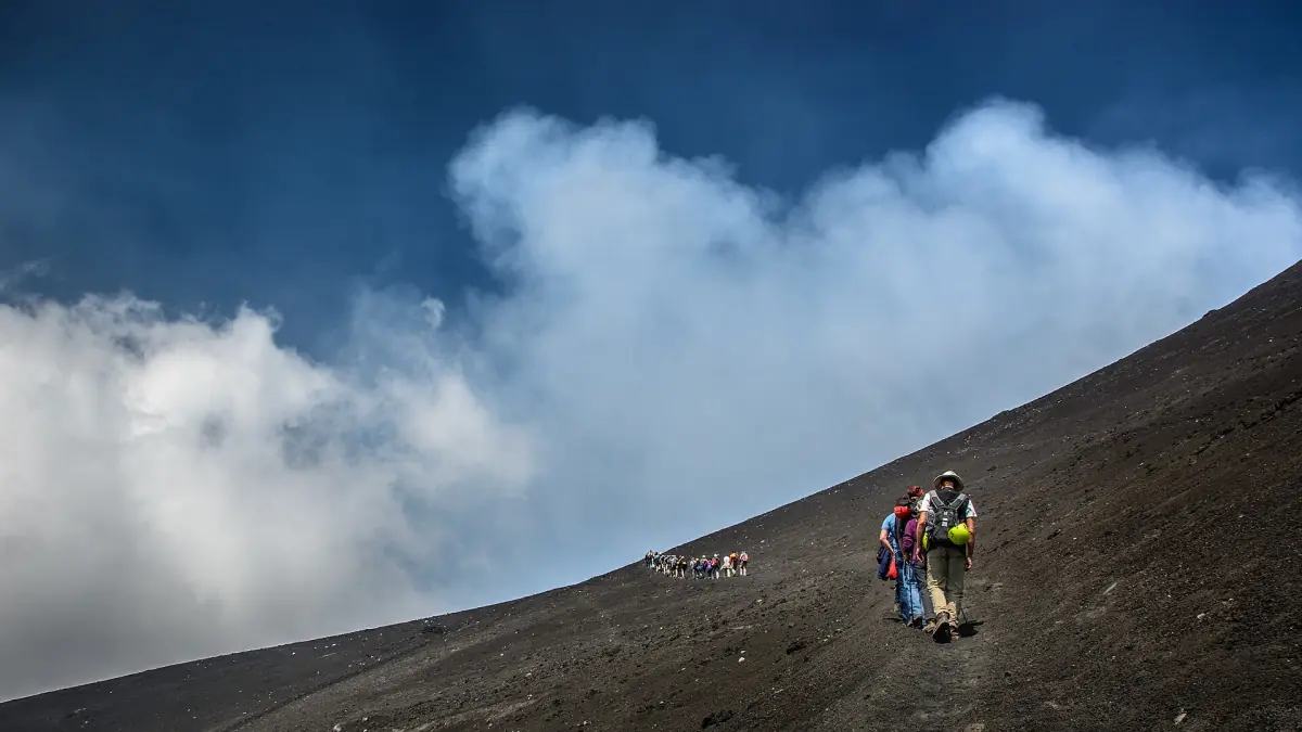 Hikers climbing towards the summit of Etna
