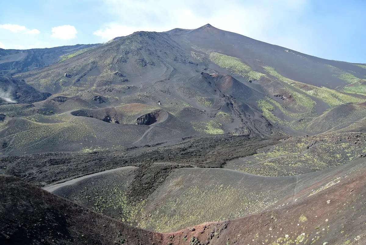The summit of Mount Etna above old lava flows